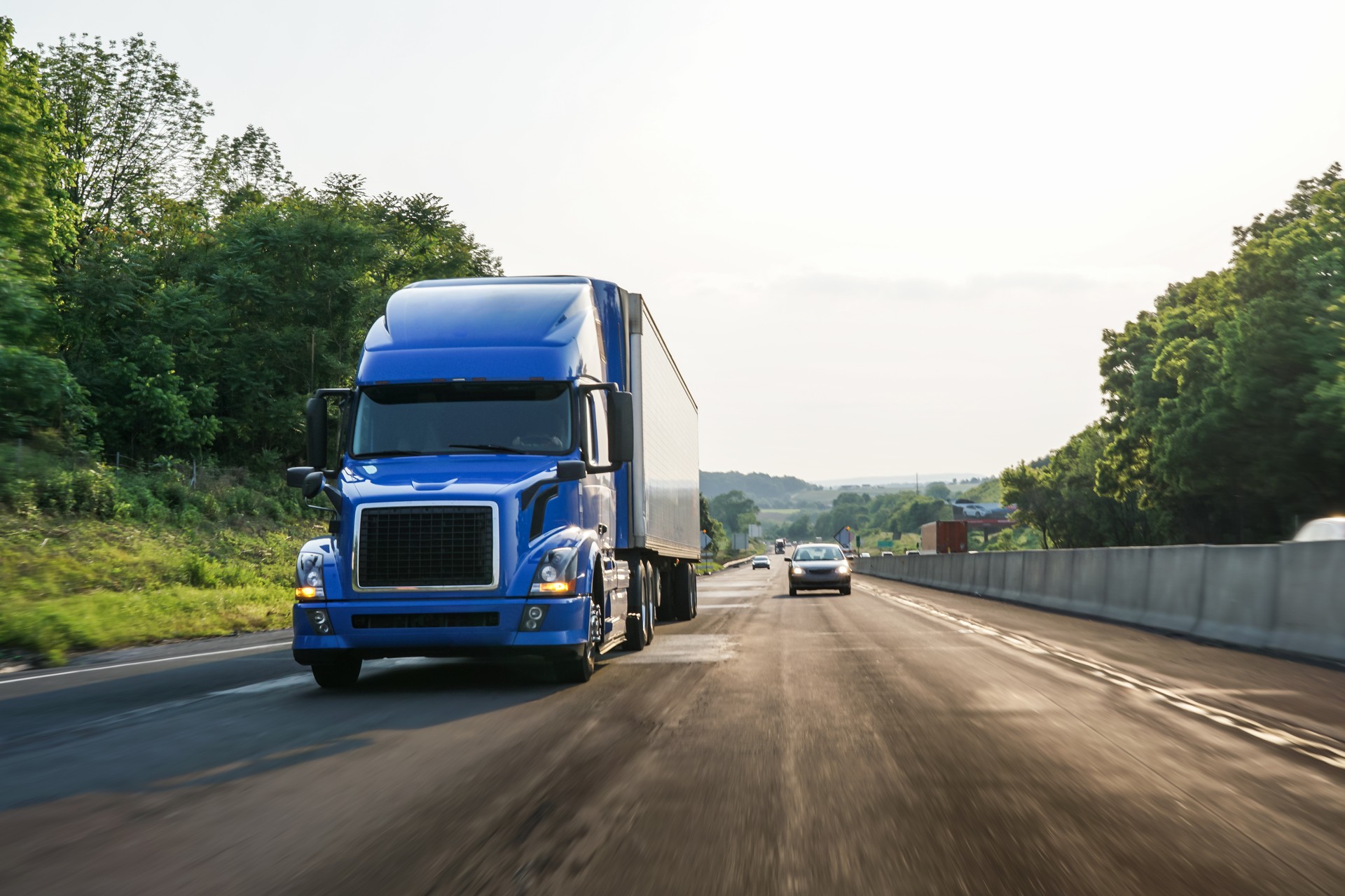 Blue commercial truck 18 wheeler on highway