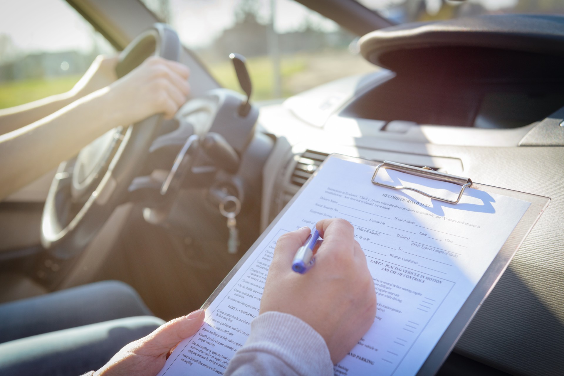 Examiner filling in driver's license road test form